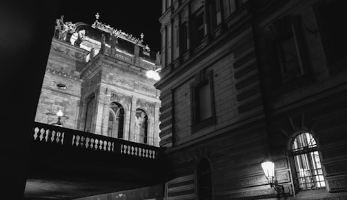 High-contrast photo of a restored heritage site entrance at dusk.