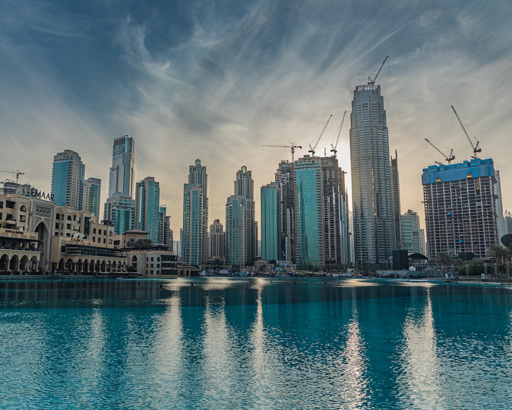 city skyline across body of water during daytime