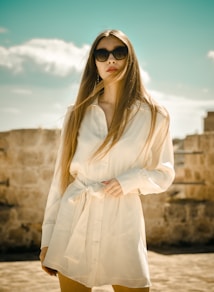 woman in white long sleeve dress wearing black sunglasses