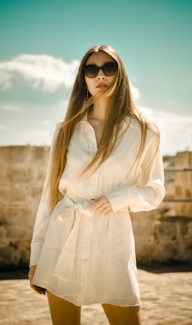 woman in white long sleeve dress wearing black sunglasses