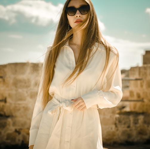 woman in white long sleeve dress wearing black sunglasses