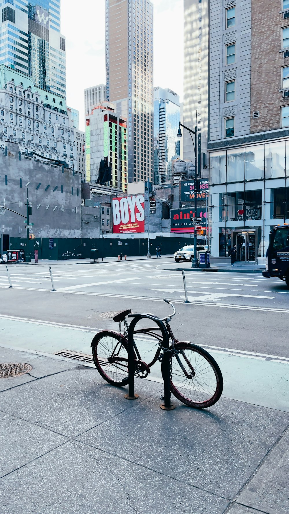 black bicycle parked on sidewalk near building during daytime