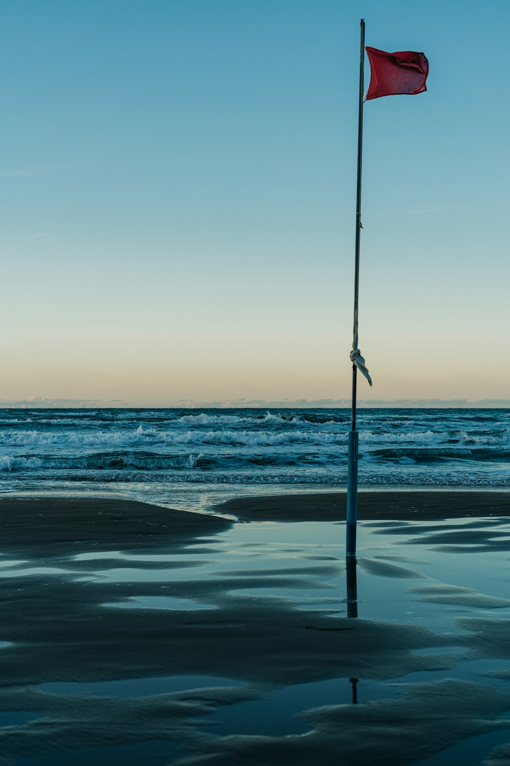 black fishing rod on seashore during daytime