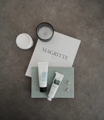 A serene flat lay of mental health books, journals, and calming candles.