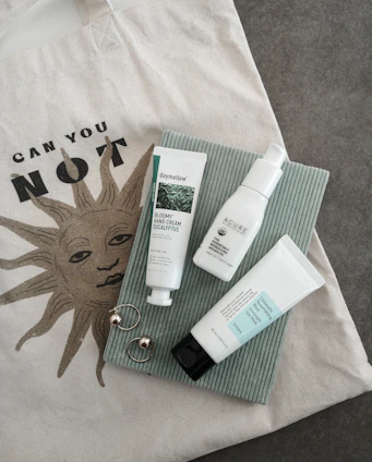 A flat lay of quirky accessories including caps and tote bags with funny slogans from the chaos collection