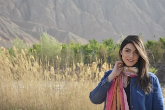 A smiling person practicing mindful breathing in nature.