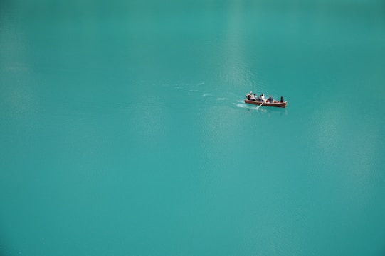 2 people riding on boat on body of water during daytime