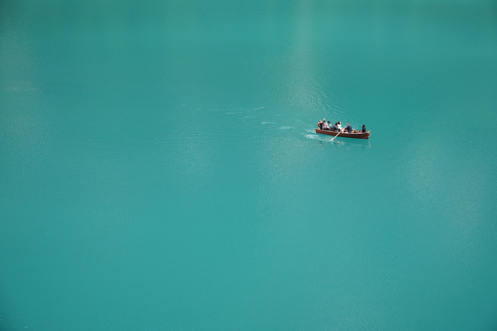 2 people riding on boat on body of water during daytime