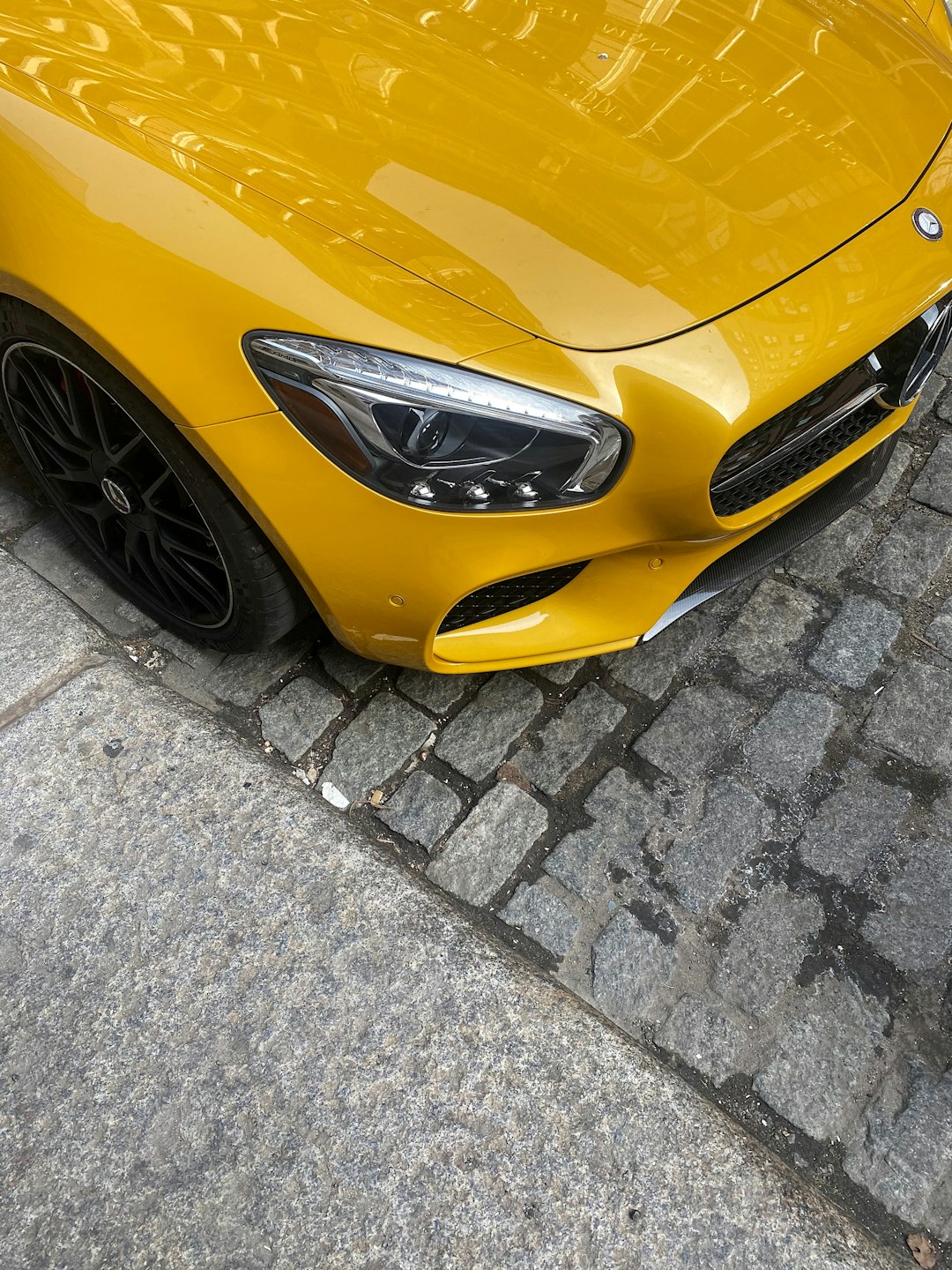 yellow car on gray brick floor