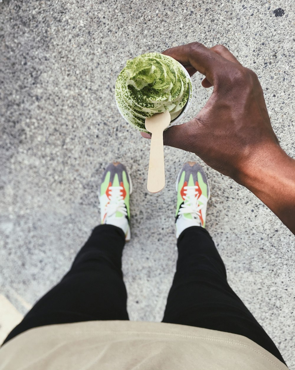 person holding green and white lollipop