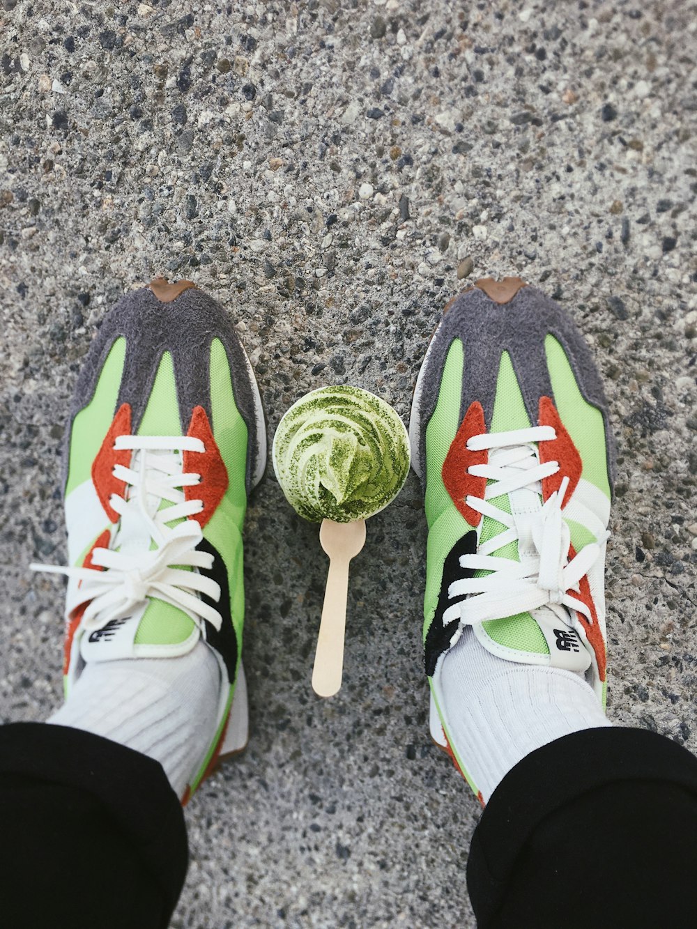 person wearing green white and black nike athletic shoes