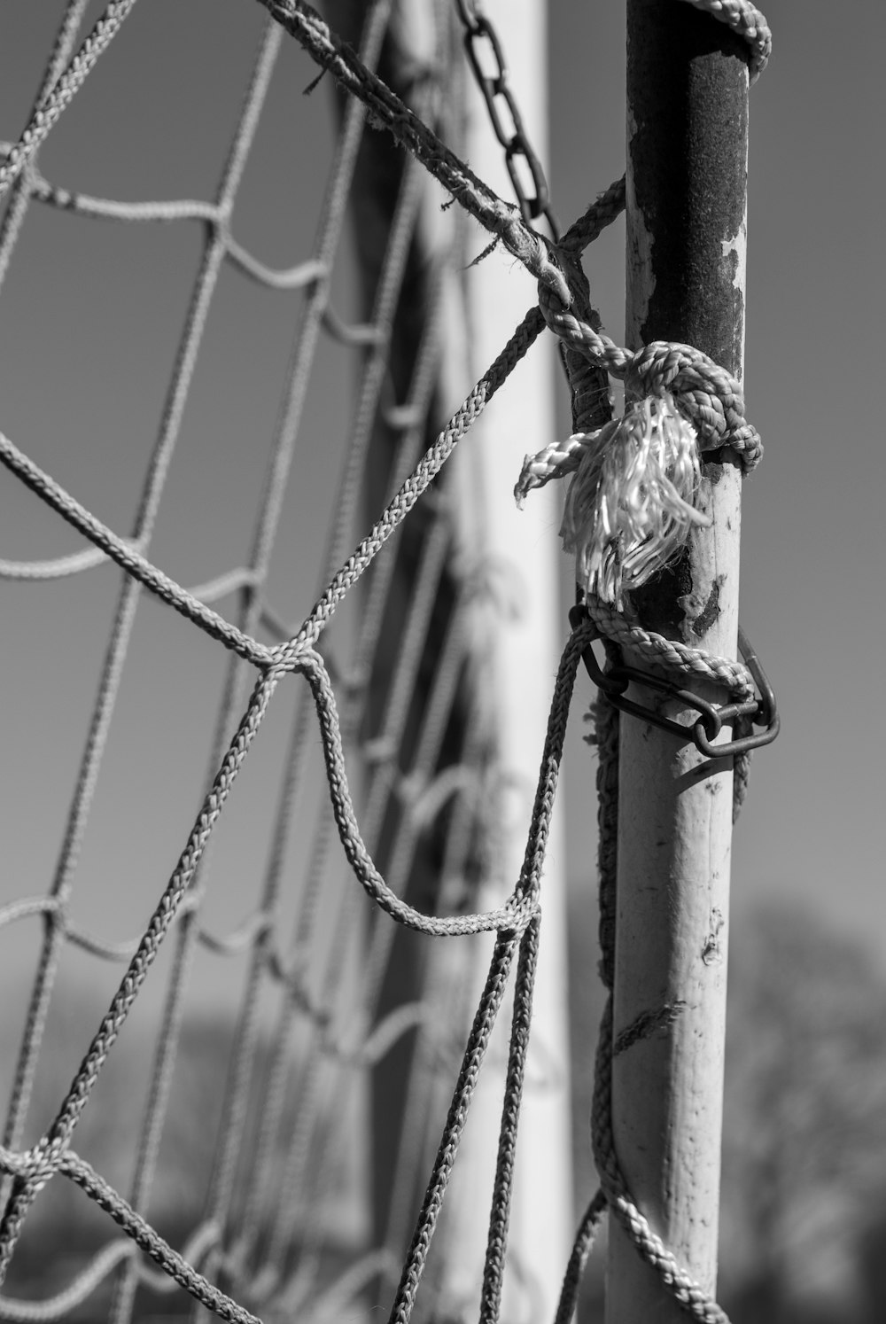 grayscale photo of a rope tied on a wire