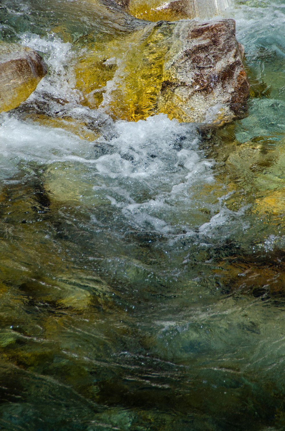 water falls in the middle of brown rocks