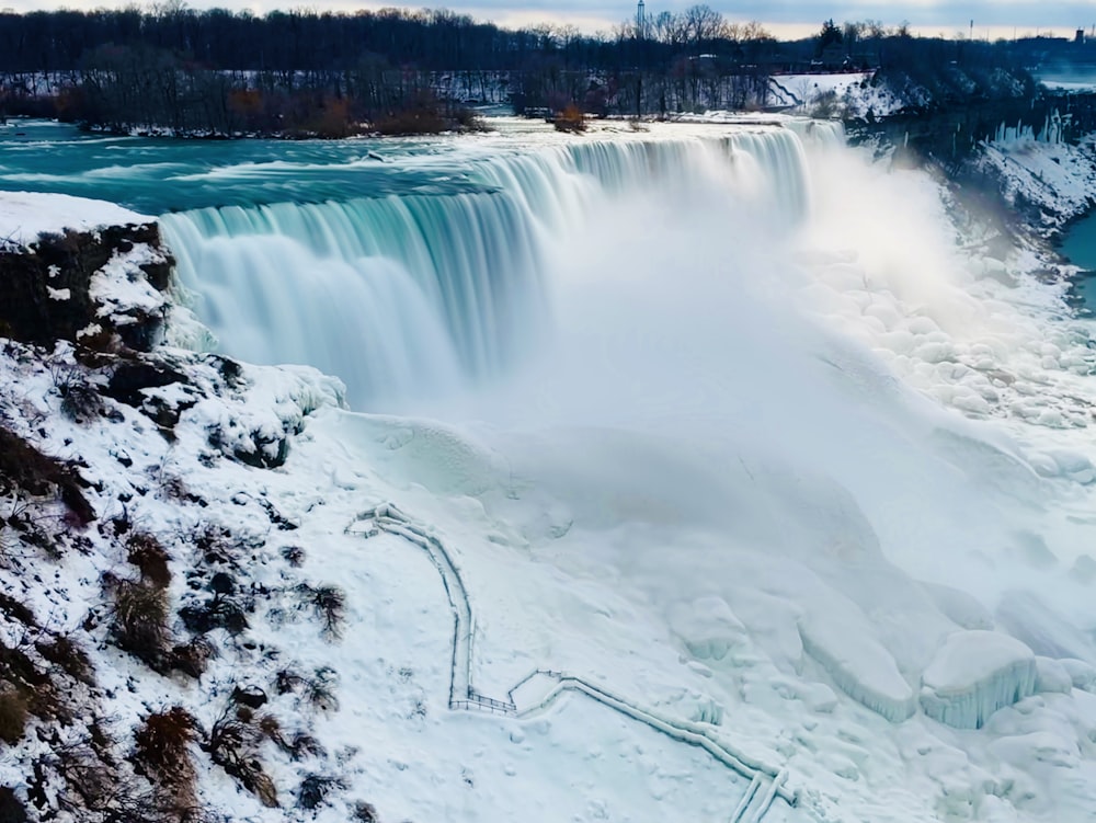 water falls with green trees