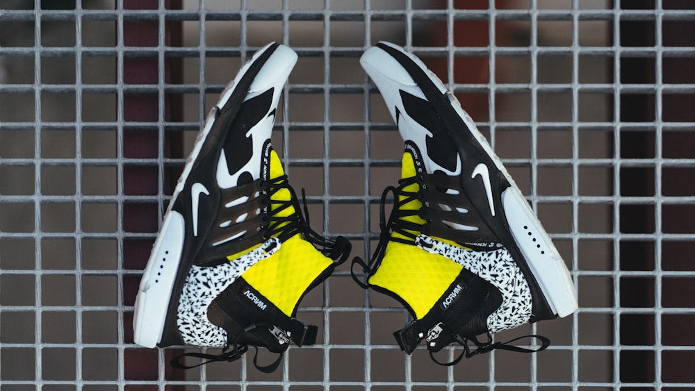 black white and yellow nike athletic shoes
