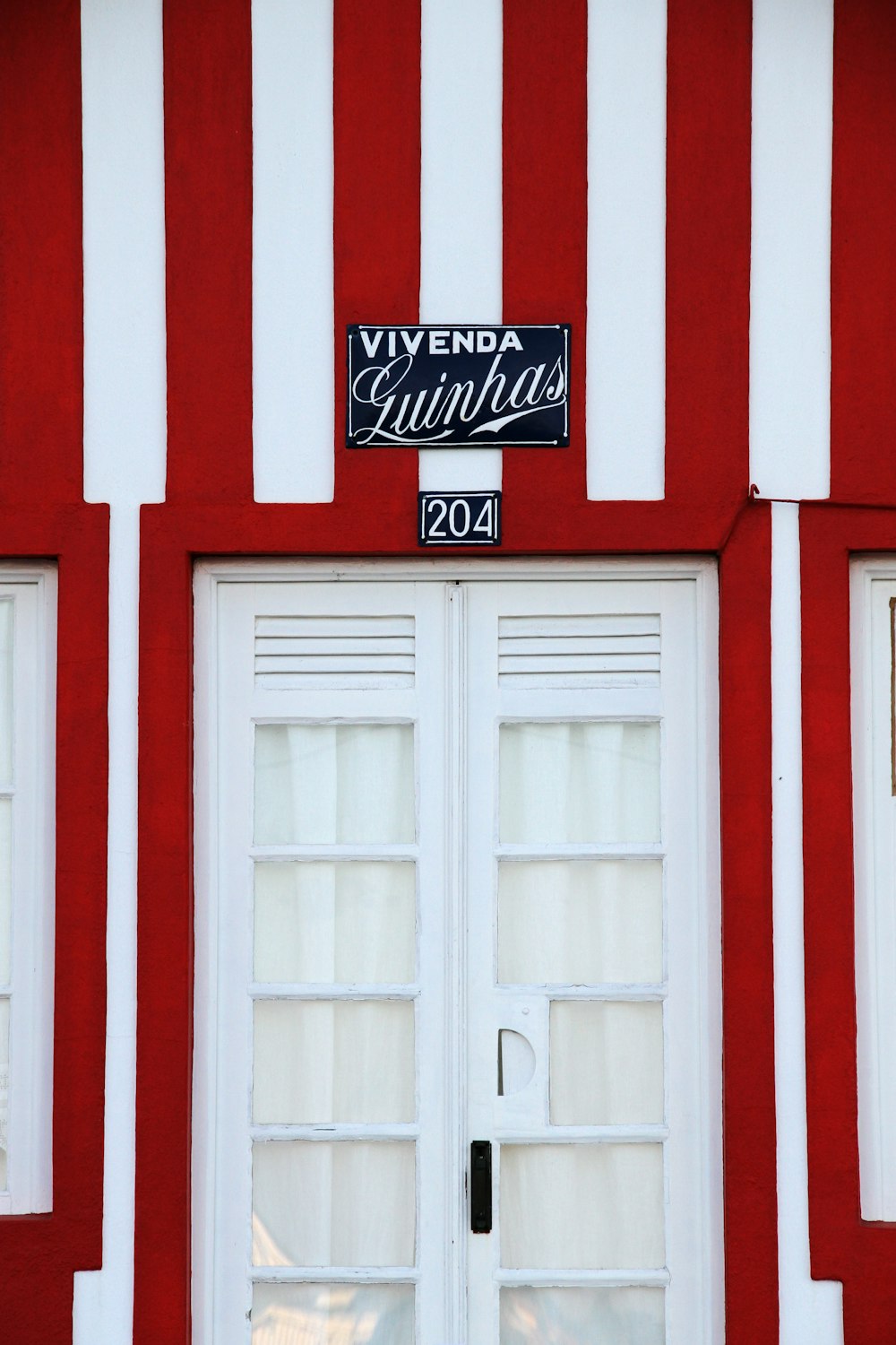 puerta de madera blanca con pared roja y blanca