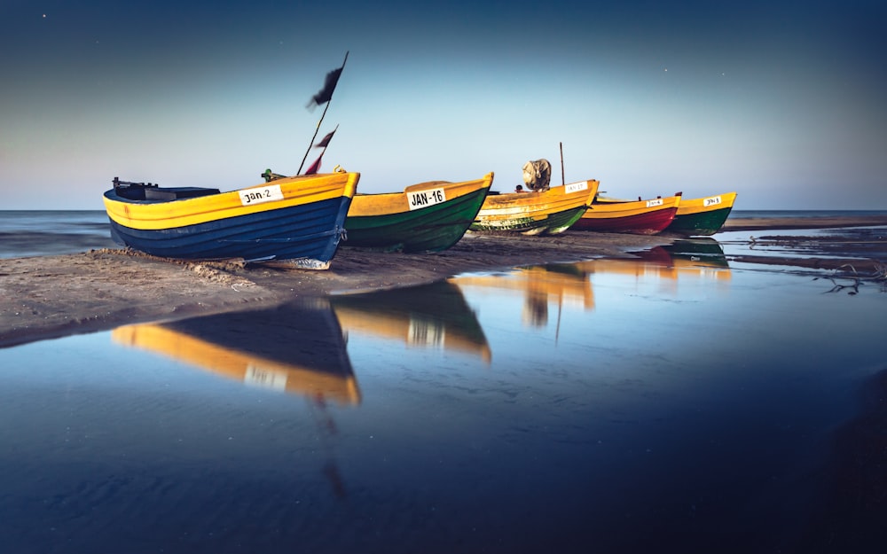 yellow and green boat on water during daytime