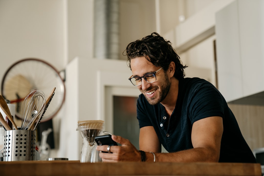 man in black crew neck t-shirt wearing black framed eyeglasses