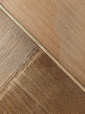 Aerial view of a farm with geometric patterns created by irrigation and planting.