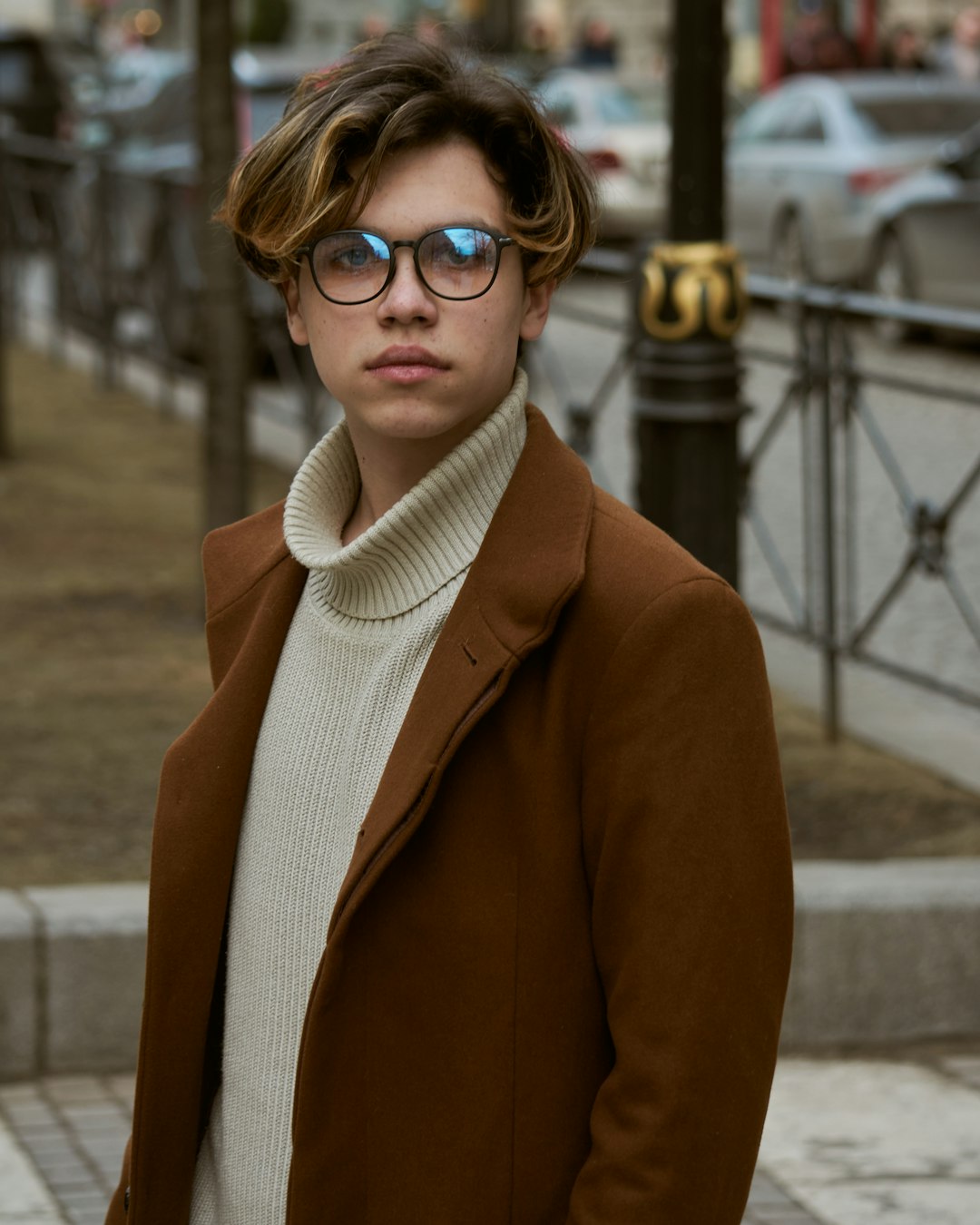 woman in brown blazer wearing black framed eyeglasses