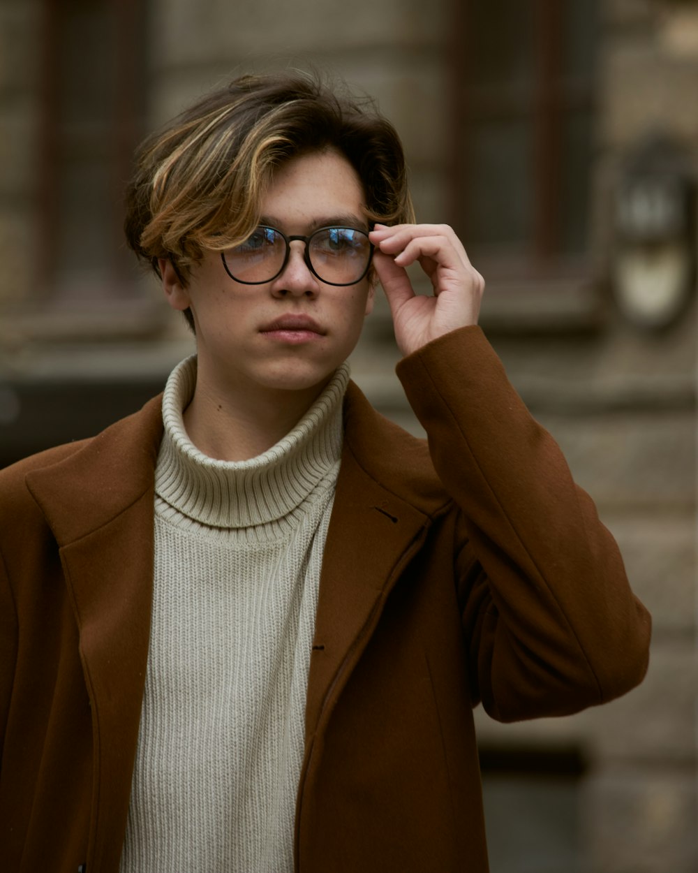 woman in brown coat wearing black framed eyeglasses