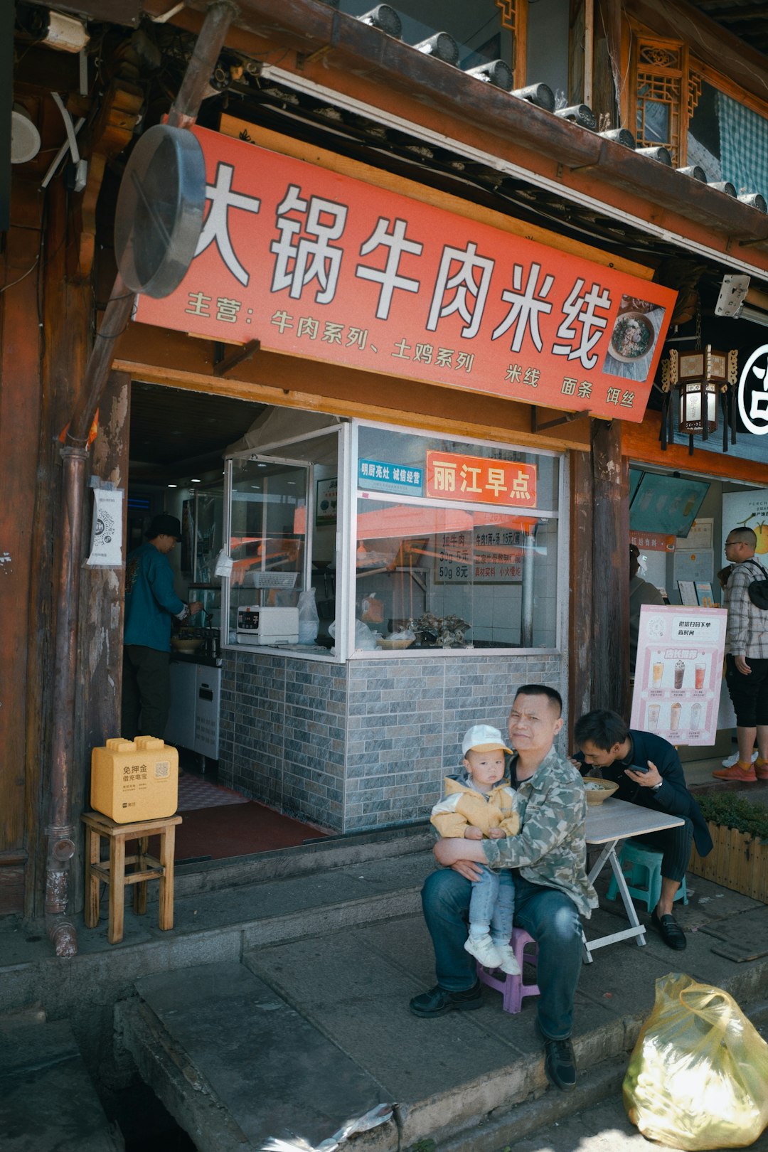 man and woman sitting on chair in front of store