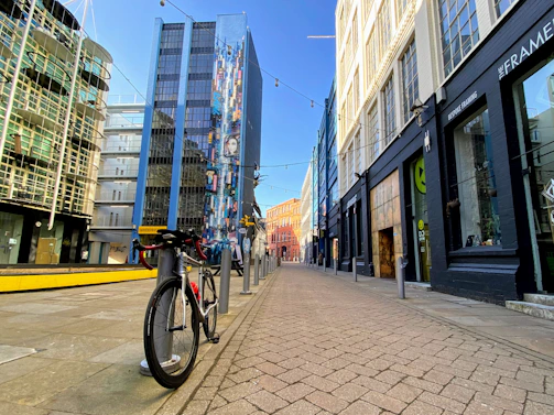 A vibrant city bike parked near a colorful mural, capturing urban cycling culture.