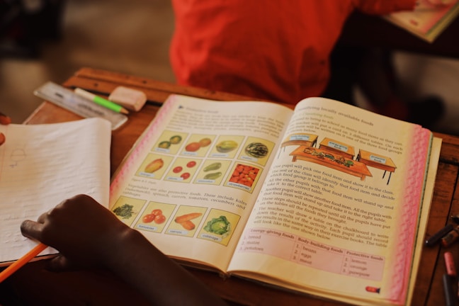 A colorful textbook cover showing children exploring nature with magnifying glasses.