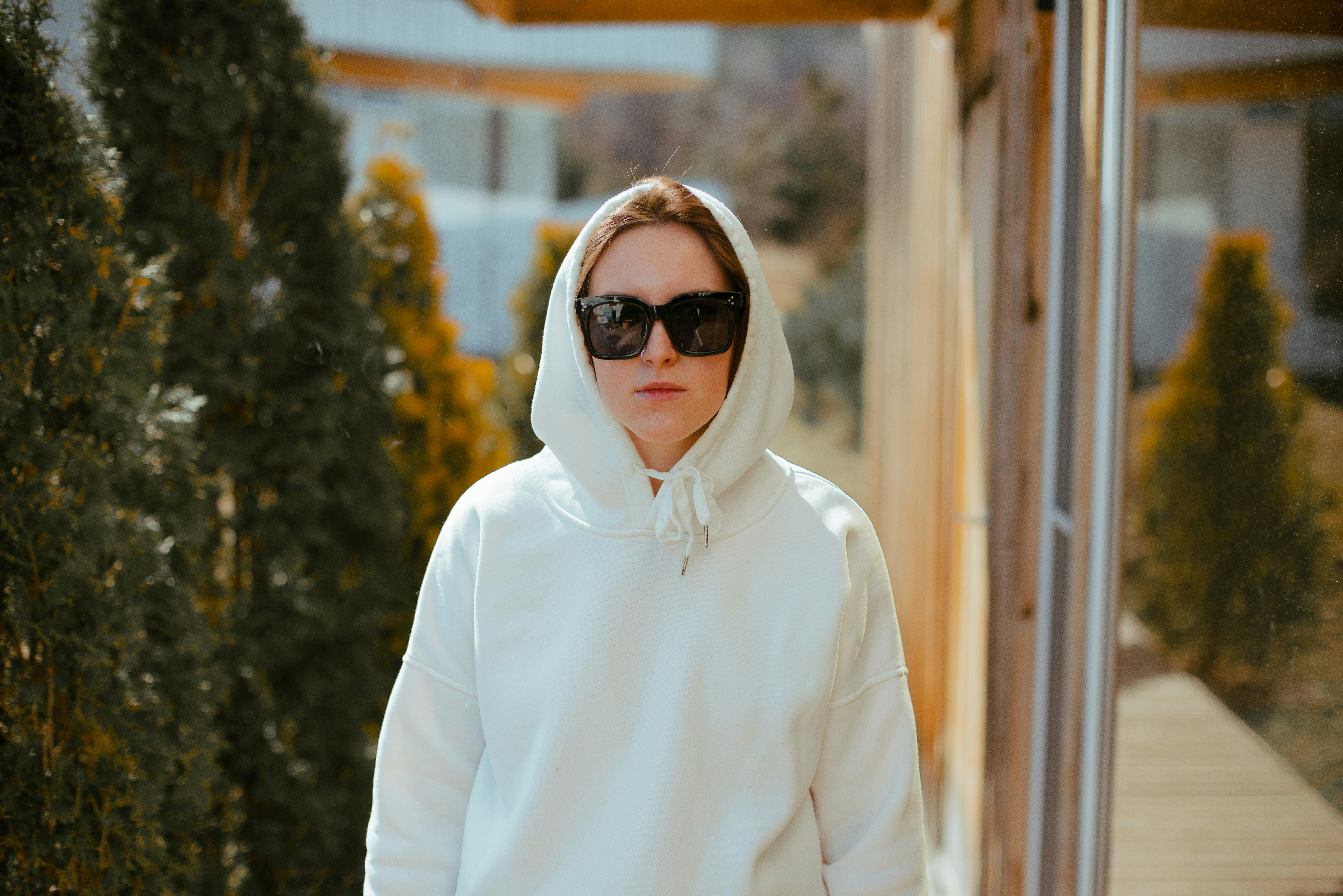Person wearing oversized neutral hoodie and cargo pants in urban setting