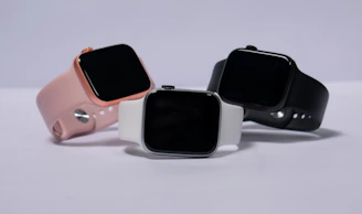 A lineup of smartwatches in different styles and colors displayed elegantly on a minimalist surface.