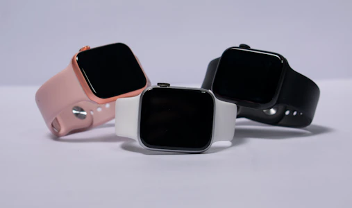 A lineup of smartwatches in different styles and colors displayed elegantly on a minimalist surface.