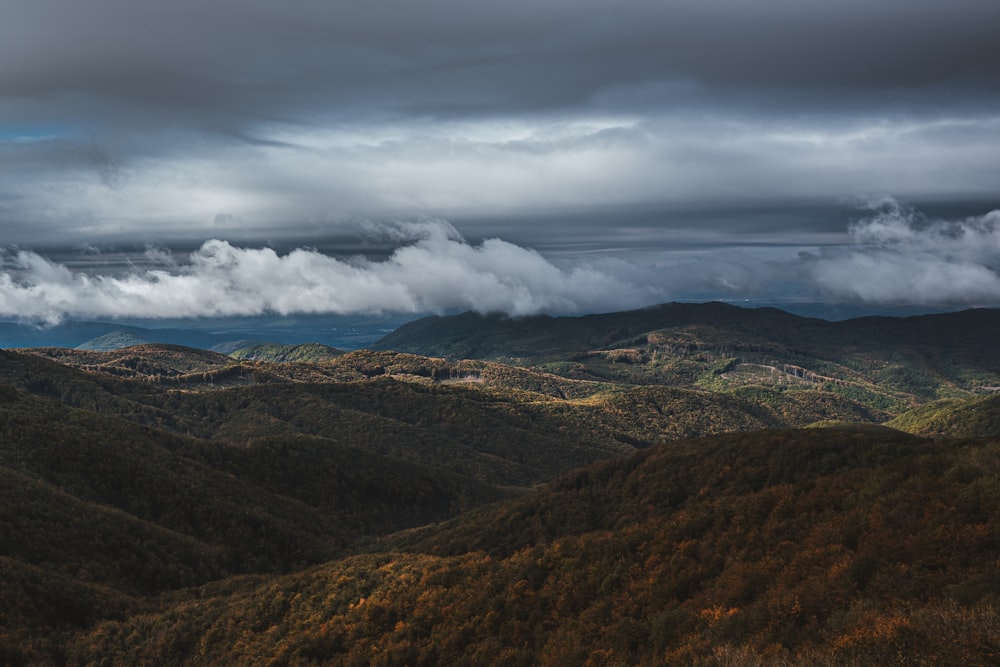 green and brown mountains under white clouds during daytime