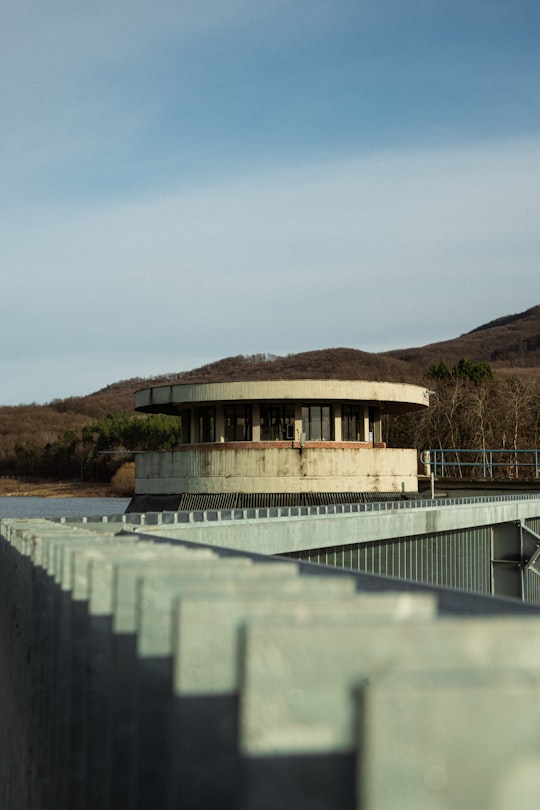 brown and white concrete building near body of water during daytime in Pásztó Hungary