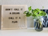 brown wooden quote board on white wall