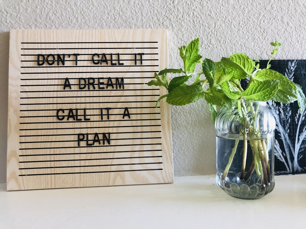 brown wooden quote board on white wall