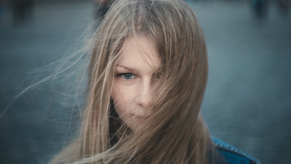 woman in blue shirt looking down