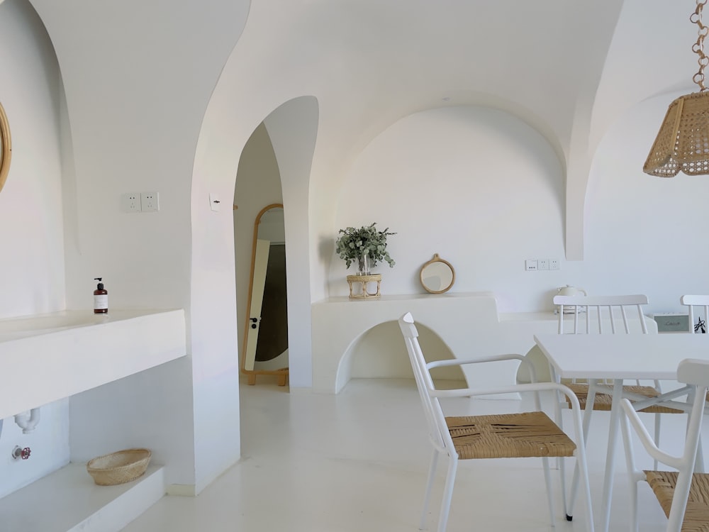 white chairs and table in white room