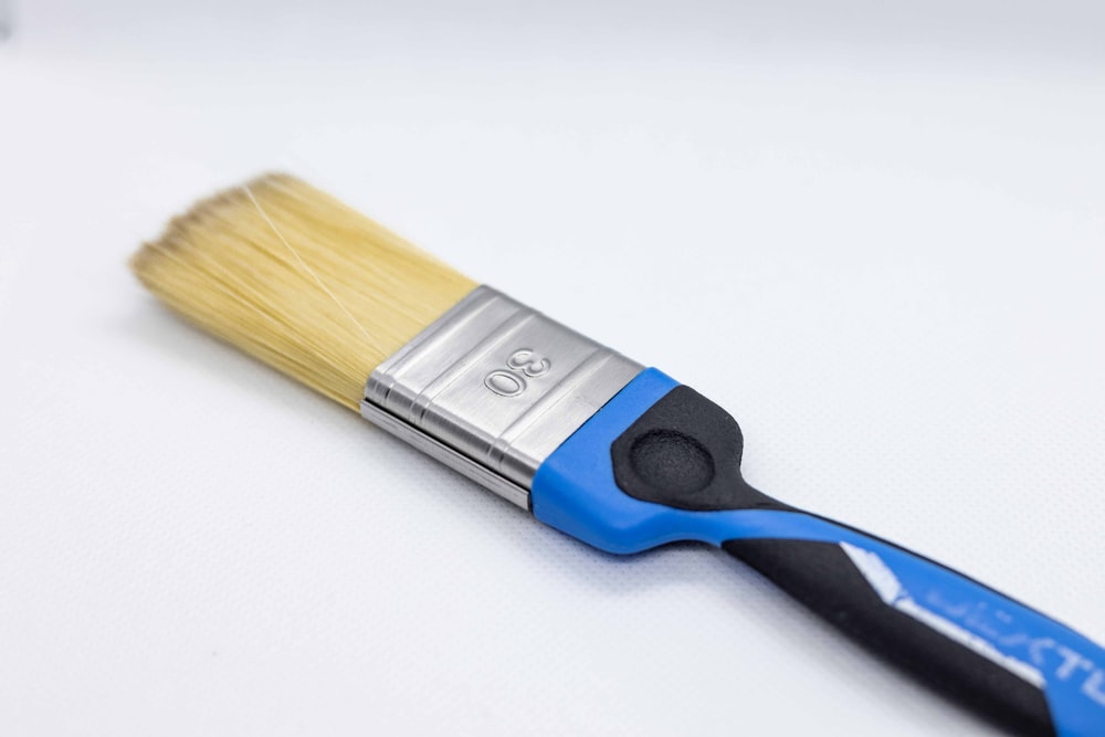 blue and brown handle brush