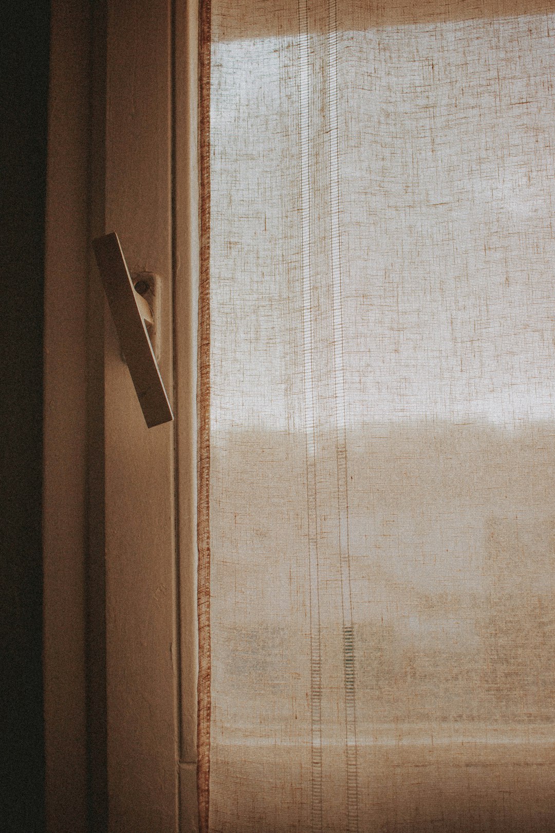 white window curtain on brown wooden door