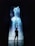 A silhouette of a person stands in front of a tall, vertical digital display showcasing vibrant blue and white light resembling a waterfall or abstract liquid flow against a dark background.
