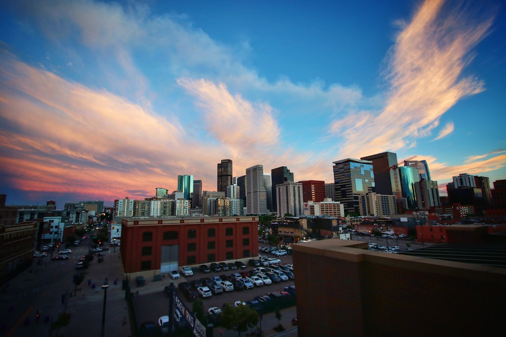 city buildings under blue sky and white clouds during daytime