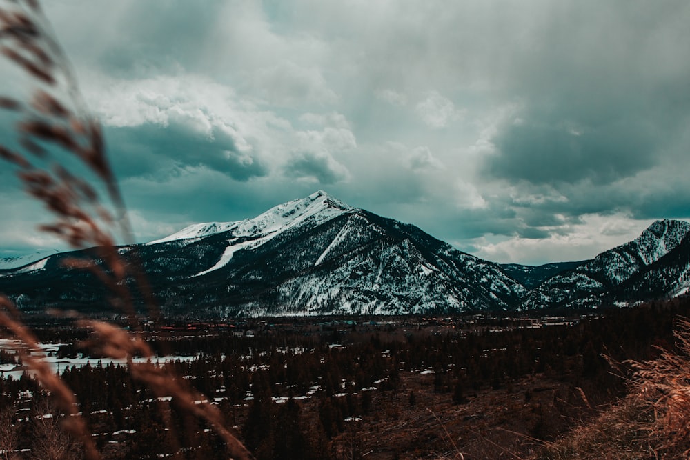 snow covered mountain under cloudy sky during daytime