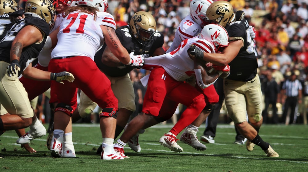 football players on green grass field during daytime