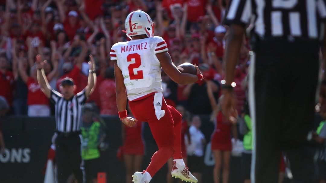 football players in red and white jersey shirt