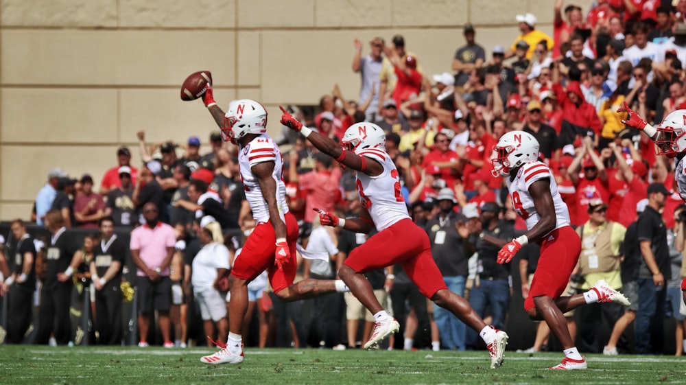 football players in red and white jersey shirt