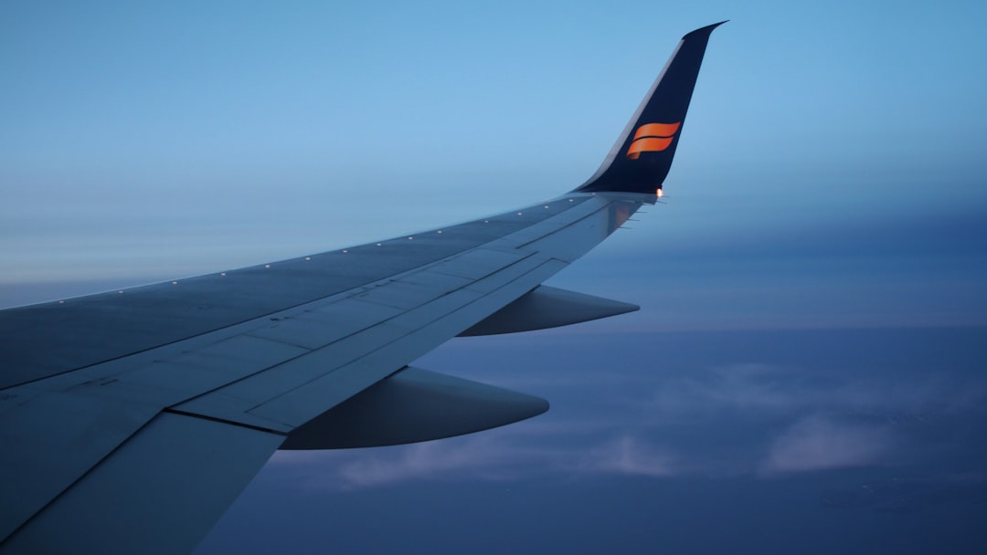 airplane wing under blue sky during daytime