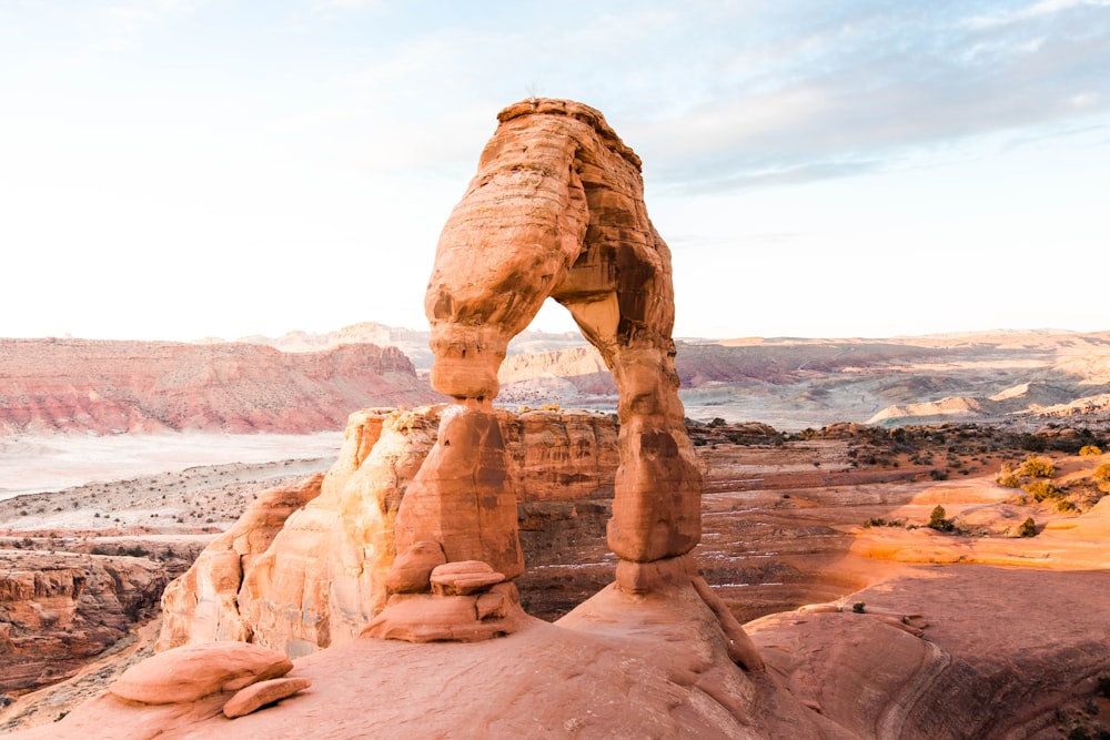 brown rock formation near body of water during daytime