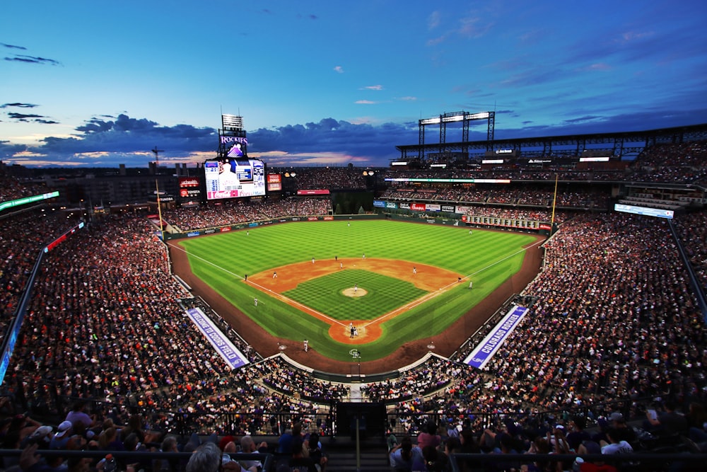 people watching baseball game during night time