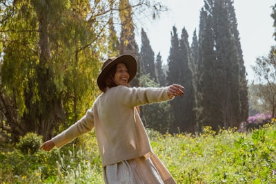 Happy person outdoors enjoying nature, symbolizing wellness and energy.