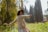 A cheerful person enjoying a healthy lifestyle outdoors, surrounded by nature.